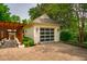 Detached garage featuring a modern design, a pergola covered walkway, and a well-maintained driveway at 220 Glandon Dr, Chapel Hill, NC 27514