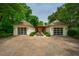 Exterior view of symmetrical garages connected by a pergola-covered walkway, enhancing curb appeal at 220 Glandon Dr, Chapel Hill, NC 27514