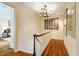Hallway featuring hardwood floors, chandelier and view into bedroom at 220 Glandon Dr, Chapel Hill, NC 27514