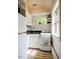Cozy kitchen with white cabinets, compact appliances, and a bright window for natural light at 220 Glandon Dr, Chapel Hill, NC 27514