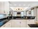 Modern kitchen featuring bar counter with sink overlooking living room fireplace at 220 Glandon Dr, Chapel Hill, NC 27514