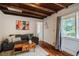 Comfortable living room featuring hardwood floors, wooden beam ceilings, and natural light at 220 Glandon Dr, Chapel Hill, NC 27514