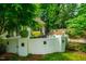 Outdoor patio with stylish seating, surrounded by a white brick wall, greenery, and a tranquil garden setting at 220 Glandon Dr, Chapel Hill, NC 27514