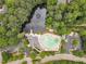 Aerial view of community pool, pond and clubhouse surrounded by mature trees at 221 Mint Hill Dr, Cary, NC 27519