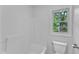 Bathroom featuring a tub, toilet, and natural light from the window at 221 Mint Hill Dr, Cary, NC 27519