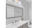 Bathroom featuring a large mirror, modern fixtures, and a white countertop at 221 Mint Hill Dr, Cary, NC 27519