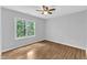 Comfortable bedroom with light walls, wood-look floors, and natural lighting at 221 Mint Hill Dr, Cary, NC 27519