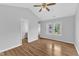 Bright bedroom featuring hardwood floors, a ceiling fan, and large window views at 221 Mint Hill Dr, Cary, NC 27519