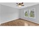 Empty bedroom with ceiling fan and view of nature through double windows at 221 Mint Hill Dr, Cary, NC 27519