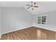A bright bedroom boasts hardwood floors, a ceiling fan, and lots of natural light at 221 Mint Hill Dr, Cary, NC 27519
