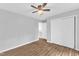 Inviting bedroom with wood-look floors, white closet doors, and neutral paint at 221 Mint Hill Dr, Cary, NC 27519
