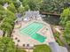 Aerial view of the community pool and clubhouse with tables, lounge chairs, and landscaping at 221 Mint Hill Dr, Cary, NC 27519