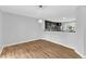 Open-concept dining room with hardwood floors, modern lighting, and a view of the kitchen at 221 Mint Hill Dr, Cary, NC 27519