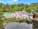 Beautiful clubhouse exterior with lakeside views, pool and sun loungers, perfect for recreation at 221 Mint Hill Dr, Cary, NC 27519