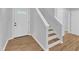 Entryway with hardwood floors, staircase, and white trim provides a welcoming and bright transition into the home at 221 Mint Hill Dr, Cary, NC 27519