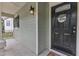 Inviting front porch featuring a stylish black door with a 'welcome' wreath and charming exterior lighting at 221 Mint Hill Dr, Cary, NC 27519