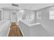 Bright hallway with modern hanging light fixture and wood-look flooring at 221 Mint Hill Dr, Cary, NC 27519