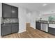 Stylish kitchen with stainless appliances and stone countertops connects to an adjacent room at 221 Mint Hill Dr, Cary, NC 27519