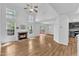 Bright living room featuring a cozy fireplace, high ceilings, and seamless flow to the kitchen and outdoor deck at 221 Mint Hill Dr, Cary, NC 27519
