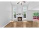 Bright living room showcasing a fireplace, hardwood floors, high ceilings, and lots of natural light at 221 Mint Hill Dr, Cary, NC 27519