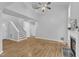 Bright and airy living room features hardwood floors, fireplace, and view of staircase and upstairs landing at 221 Mint Hill Dr, Cary, NC 27519