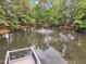A view of the lush landscaping around the pond with water fountain feature at 221 Mint Hill Dr, Cary, NC 27519