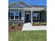 Inviting front entrance with stone accents, new landscaping, and a well-maintained lawn at 244 Kipling Crk Dr, Fuquay Varina, NC 27526