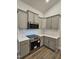 Contemporary kitchen featuring gray cabinetry, white backsplash, and stainless steel appliances at 244 Kipling Crk Dr, Fuquay Varina, NC 27526