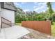 Backyard featuring a concrete patio, privacy fence, and lush trees in the background at 2616 Wedgedale Ave, Durham, NC 27703