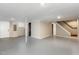 Unfinished basement area with concrete flooring, access to stairs and a utility closet at 2616 Wedgedale Ave, Durham, NC 27703