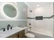 Bathroom featuring a bathtub and shower combo, modern fixtures, and decorative wainscoting at 2616 Wedgedale Ave, Durham, NC 27703