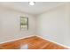 Bedroom featuring hardwood floors, neutral paint, and a window providing ample lighting at 2616 Wedgedale Ave, Durham, NC 27703
