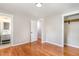 Bright bedroom featuring hardwood floors, neutral walls, closet, and access to a bathroom at 2616 Wedgedale Ave, Durham, NC 27703