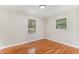 Bedroom featuring hardwood floors, neutral paint, and a single window providing ample lighting at 2616 Wedgedale Ave, Durham, NC 27703