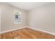 Bright bedroom featuring hardwood floors, neutral walls, and a window for natural light at 2616 Wedgedale Ave, Durham, NC 27703