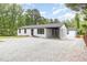 Well-maintained exterior showcasing white brick, a black roof, and a convenient carport at 2616 Wedgedale Ave, Durham, NC 27703