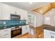 Kitchen with white cabinets, granite countertops and blue subway tile backsplash at 2616 Wedgedale Ave, Durham, NC 27703