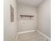 Utility room featuring a shelf and tiled flooring at 2616 Wedgedale Ave, Durham, NC 27703