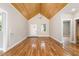 Open living space with beautiful wood floors and vaulted wood ceiling at 2616 Wedgedale Ave, Durham, NC 27703