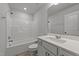 Bright bathroom with a shower-tub combo, modern vanity, and white finishes at 2617 Chert Ln, Raleigh, NC 27610