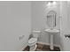 Charming powder room with a pedestal sink and wood-look flooring at 2617 Chert Ln, Raleigh, NC 27610