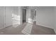 Bedroom with neutral carpet and multiple doors providing access to other rooms at 2617 Chert Ln, Raleigh, NC 27610