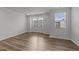 Bright bedroom featuring hardwood floors, neutral walls, and large windows offering views of the neighborhood at 2617 Chert Ln, Raleigh, NC 27610