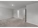 Neutral bedroom with plush carpeting, and white walls, and featuring two doors leading to different areas at 2617 Chert Ln, Raleigh, NC 27610