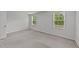 Bright bedroom featuring plush carpeting, neutral walls, and two windows providing natural light at 2617 Chert Ln, Raleigh, NC 27610