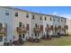 Back view of attached townhomes with cozy wooden decks overlooking the lawns at 2617 Chert Ln, Raleigh, NC 27610