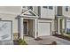 Close up of a tan and cream two-story townhome featuring an attached garage at 2617 Chert Ln, Raleigh, NC 27610