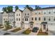 Attractive townhomes in neutral colors featuring attached garages and well maintained landscaping at 2617 Chert Ln, Raleigh, NC 27610