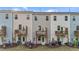 A full backyard view of recently constructed townhomes with small wooden decks at 2617 Chert Ln, Raleigh, NC 27610