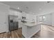 Modern kitchen featuring white cabinets, stainless steel appliances, and a center island at 2617 Chert Ln, Raleigh, NC 27610